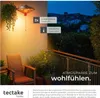 A balcony scene at dusk with a hanging heater providing warm light, a chair, and plants. Náhled obrázku produktu