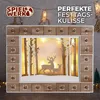A wooden advent calendar with a winter forest scene and LED lights, displayed with festive decorations. Anteprima dell’immagine prodotto