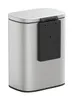 A silver trash can with a black attachment on the side, shown against a white background. Náhľad obrázku produktu