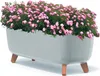 A light gray bathtub-shaped planter filled with pink roses and green foliage, resting on four brown legs. Náhľad obrázku produktu
