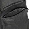 A close-up view of a zippered pocket on a gray fabric bag, revealing a silver, insulated lining. Náhled obrázku produktu