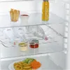Inside a refrigerator, showing shelves with food and drinks. Voir les images du produit