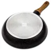 The underside of a frying pan with a textured base and a wooden handle. Náhľad obrázku produktu