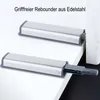 Two push-to-open door latches are shown on a white surface, with one partially extended. Produktbild-Vorschau