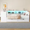 A white bed with storage drawers and a built-in shelf unit with LED lighting. Podgląd zdjęcia produktu