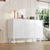 A white sideboard with decorative arches is placed in a well-lit room with a large window and natural light. Voir les images du produit