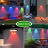 A collage of four images showing solar wall lights illuminating outdoor spaces with colorful light. Produktbild-Vorschau