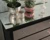 Decorative items on a mirrored surface, likely a dresser or table. Náhľad obrázku produktu