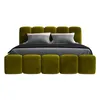 A bed with a green upholstered headboard and frame, with gray pillows and bedding. Produktbild-Vorschau