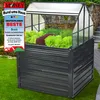A raised garden bed with a greenhouse top, filled with various plants, set in a garden environment. Produktbild-Vorschau