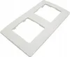 A white plastic frame with two square openings for electrical outlets or switches, shown on a white background. Náhľad obrázku produktu