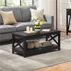 A black coffee table with a shelf is placed in a living room setting in front of a grey sofa. Produktbild-Vorschau