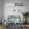 A nursery room with a crib, mobile, and decorations. Produktbild-Vorschau