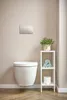 A modern bathroom with a wall-mounted toilet and a small shelving unit. Náhľad obrázku produktu