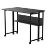 A black folding table with shelves and wheels, shown from a front-side angle against a white background. Produktbild-Vorschau