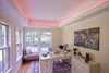 A home office with a desk, computer, and a world map on the wall, illuminated by pink LED strip lights on the ceiling. Podgląd zdjęcia produktu