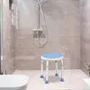A shower stool is placed in a modern shower stall next to a toilet. Produktbild-Vorschau