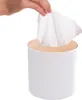 A hand pulling a tissue from a white tissue box with a wooden lid. Náhľad obrázku produktu