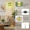 A living room scene with a floor lamp, sofa, and plant, accompanied by feature callouts. Anteprima dell’immagine prodotto
