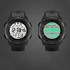 Two black digital sport watches are shown side-by-side against a dark gray background. The watch on the left has a white display, while the watch on the right has a green display. Both watches show the time 12:38:46. Náhled obrázku produktu