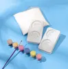 A craft set with molds, paint pots, and a brush laid out on a blue background. Produktbild-Vorschau