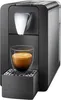 A close-up studio shot of a black Cremesso Compact One II espresso machine with a glass cup of espresso. Voir les images du produit
