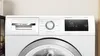 Close-up of the control panel and drum of a white Bosch washing machine. Produktbild-Vorschau
