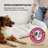 A person is using a handheld cleaning device on a dog bed with stains, while a dog lies nearby. Podgląd zdjęcia produktu