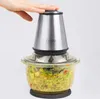 A hand pressing the top of a food chopper with chopped ingredients inside. Produktbild-Vorschau