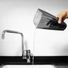 A hand is pouring water from a black vacuum cleaner dustbin into a sink next to a chrome faucet. Podgląd zdjęcia produktu