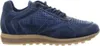 A side view of a blue sneaker with a brown sole against a white background. Voir les images du produit