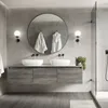 A modern bathroom with a double vanity, round mirror, and shower. Podgląd zdjęcia produktu