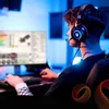 A person wearing a gaming headset and playing on a computer. Voir les images du produit