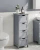 A gray bathroom cabinet with four drawers is shown next to a toilet, with a sink and another cabinet visible in the background. Náhled obrázku produktu