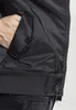 A close-up view of a person's hand in the pocket of a black bomber jacket. Produktbild-Vorschau