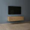 A wall-mounted TV cabinet and television in a room with wooden flooring. Produktbild-Vorschau