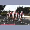A group of cyclists in uniform riding on a road. Voir les images du produit