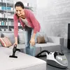 A woman is vacuuming a sofa in a modern living room. Produktbild-Vorschau