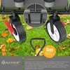 Close-up of a garden wagon's wheels and handle on grass with fallen leaves. Produktbild-Vorschau