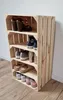 A wooden shoe rack made from crates, filled with various shoes. Produktbild-Vorschau