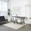 A modern office or living space with a desk, chair, lamp, and a world map on the wall. Produktbild-Vorschau