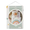 Product packaging for a children's bedding set, featuring a circular window showcasing the duvet cover and pillowcase with a rainbow and sun design. Produktbild-Vorschau