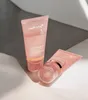 Two tubes of pink collagen night wrapping mask are placed on a light-colored surface with shadows. Produktbild-Vorschau