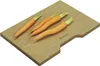 Four carrots on a wooden cutting board. Podgląd zdjęcia produktu