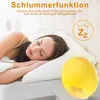 A woman sleeping in bed next to a sunrise alarm clock. Produktbild-Vorschau