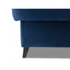 A close-up view of the bottom corner of a blue velvet ottoman with black wooden legs. Náhľad obrázku produktu