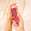 Hands holding a bottle of Durex Play Sweet Strawberry lubricant. Produktbild-Vorschau