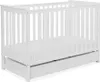 A white baby crib with a drawer underneath, shown from a slightly elevated side angle against a white background. Produktbild-Vorschau