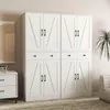 A white cabinet with four doors and drawers, placed in a room with a painting on the wall and a plant. Podgląd zdjęcia produktu