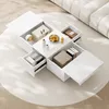 A white rectangular coffee table with multiple drawers open, displaying storage contents, placed on a light-colored rug in a living room setting. Produktbild-Vorschau